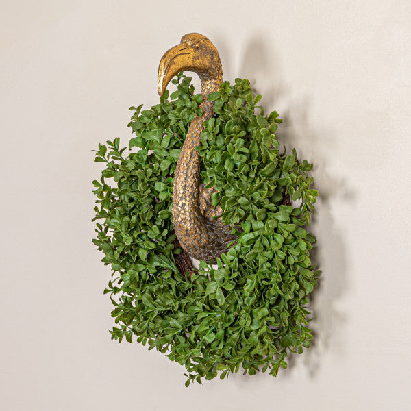 A circular green faux boxwood wreath made from plastic leaves, designed for use as a decorative gardening accessory.